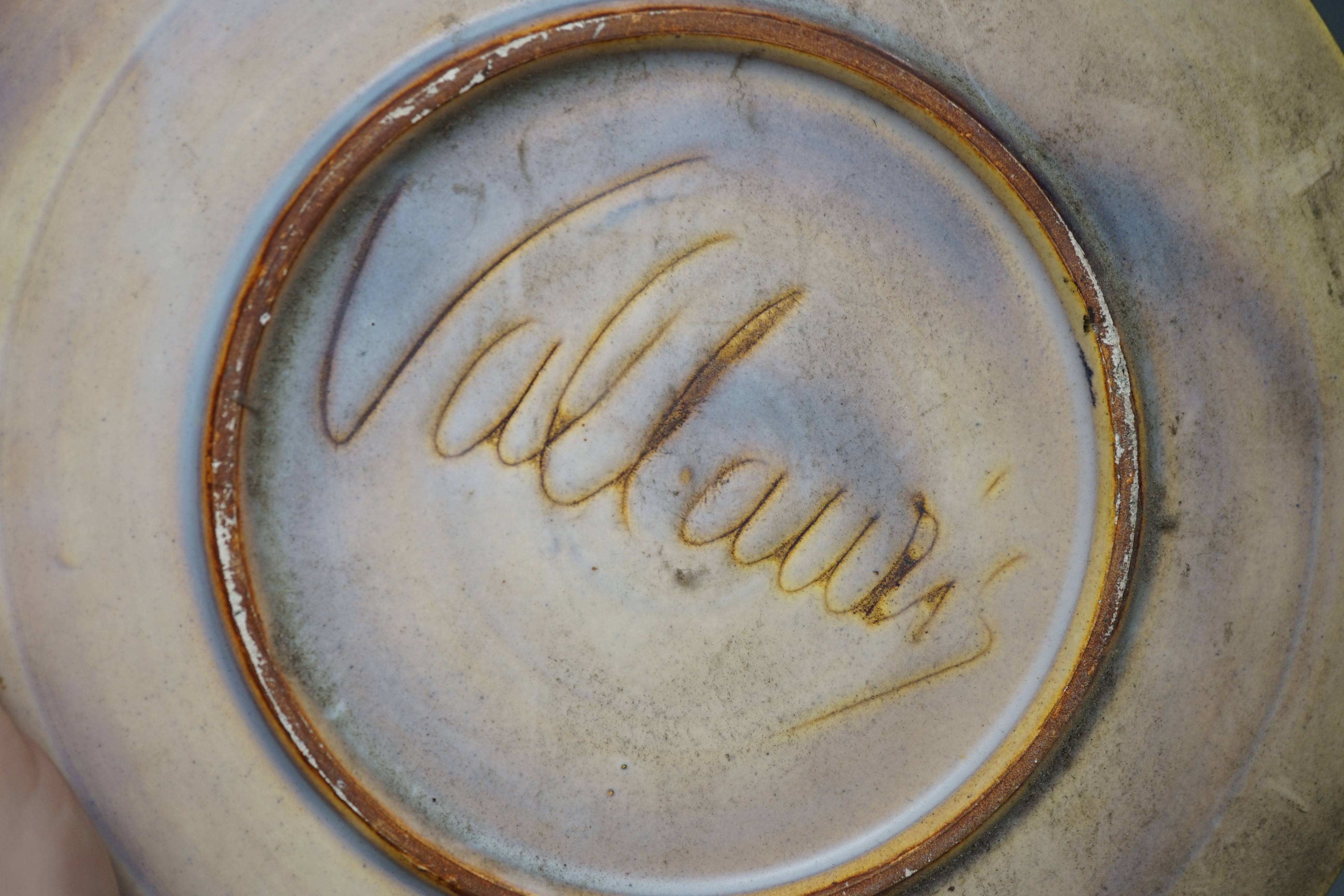 A selection of ceramics, to include two Vallauris plates, a bust of Madonna and child signed ‘Helen Fraser Rock 1925’, a Dutch figure and a pair of turquoise glazed cats etc.